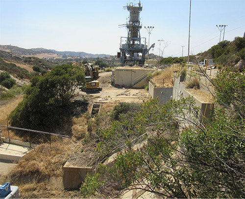 This photo is looking east from Alfa Test Stand #3 toward Alfa Test Stand #2. A large structure and a staircase is seen at the base of the test stand.